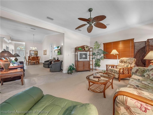 tiled living room with ornamental molding and ceiling fan with notable chandelier