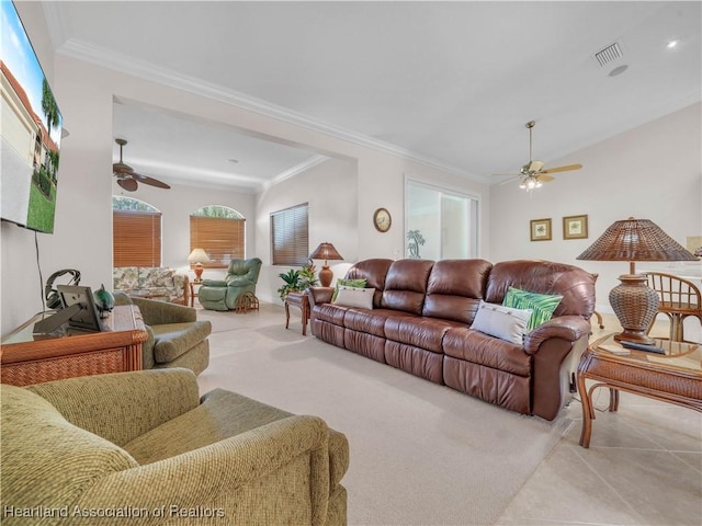 living room featuring ceiling fan, ornamental molding, and light carpet