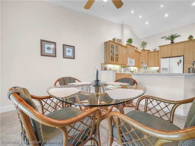 tiled dining room featuring crown molding, ceiling fan, and high vaulted ceiling