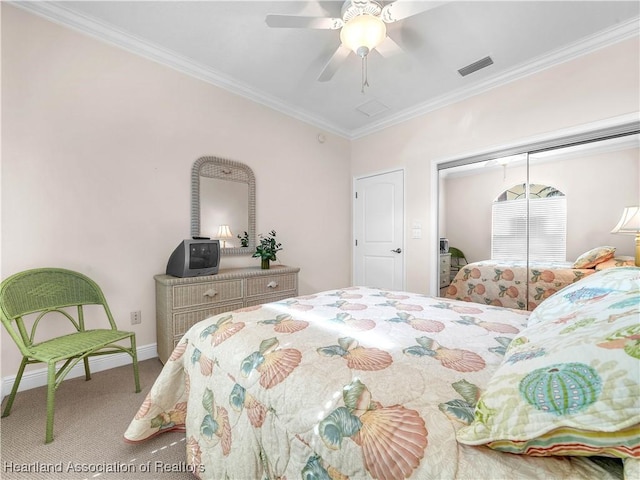 bedroom with carpet floors, ornamental molding, a closet, and ceiling fan