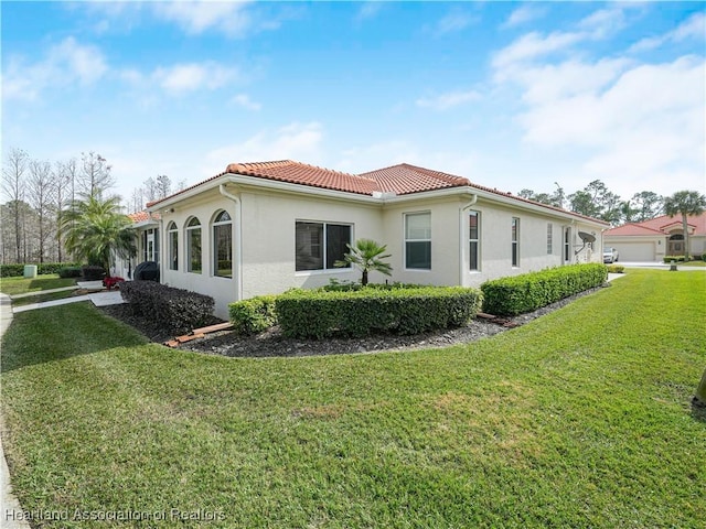 view of side of home with a yard