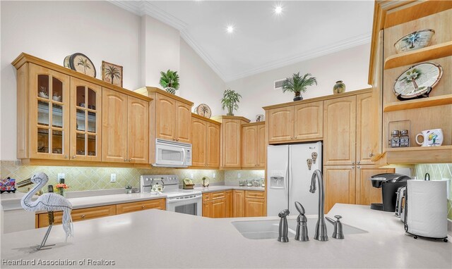 kitchen with light tile patterned flooring, white appliances, and backsplash