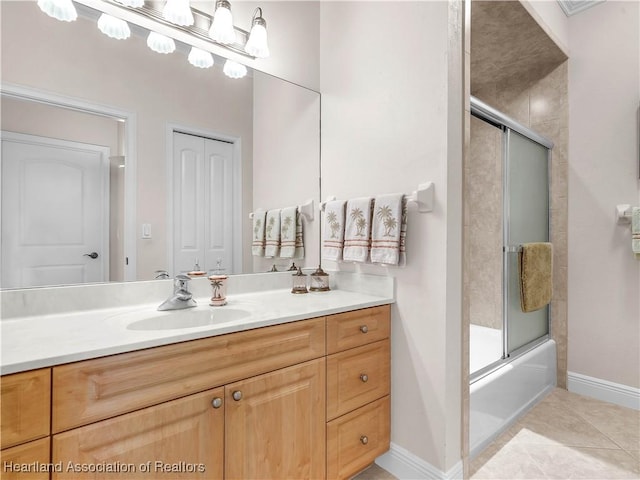 bathroom with vanity, tile patterned flooring, and bath / shower combo with glass door