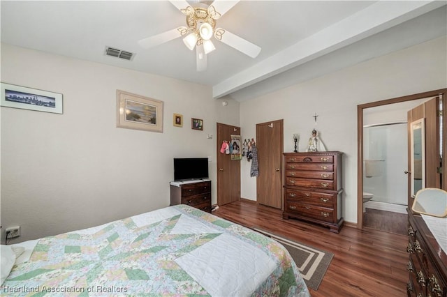 bedroom with ceiling fan, beam ceiling, dark wood-type flooring, and ensuite bath