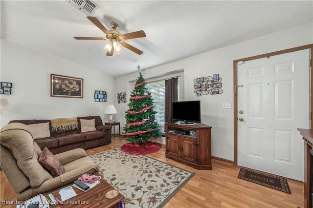 living room with ceiling fan and light wood-type flooring