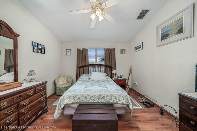 bedroom with ceiling fan and dark hardwood / wood-style flooring