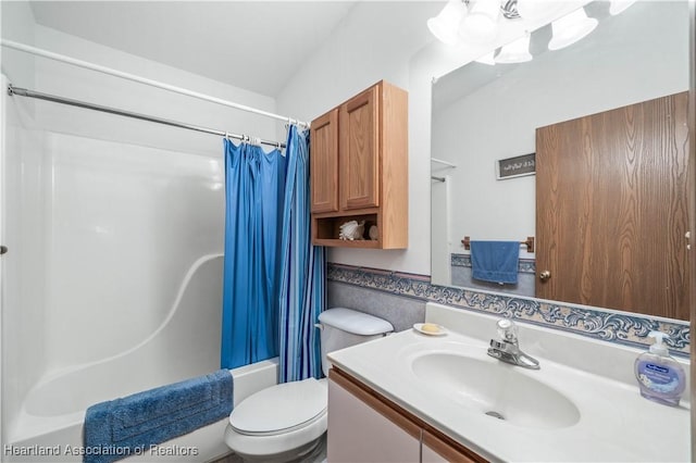 full bathroom featuring vanity, shower / bathtub combination with curtain, and toilet