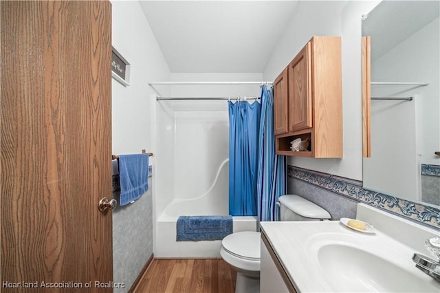 full bathroom featuring vanity, hardwood / wood-style flooring, toilet, and shower / bath combo with shower curtain