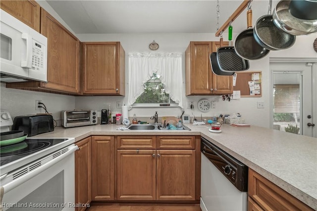 kitchen featuring white appliances, sink, and a wealth of natural light