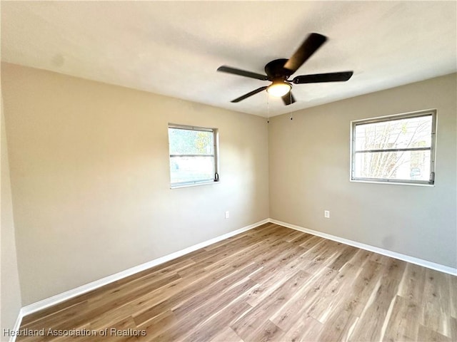 empty room featuring ceiling fan and light hardwood / wood-style floors