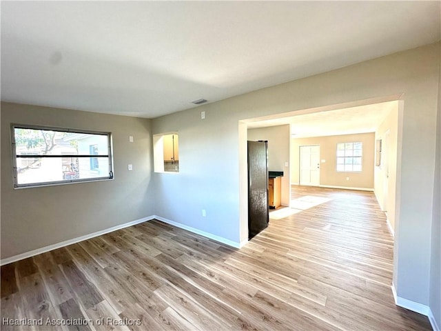 empty room with light hardwood / wood-style floors