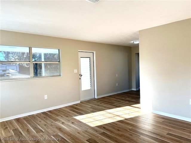 empty room with hardwood / wood-style flooring