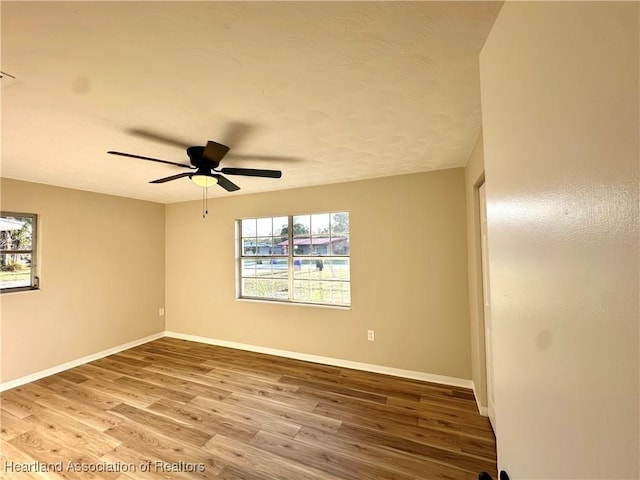 unfurnished room featuring ceiling fan and hardwood / wood-style floors