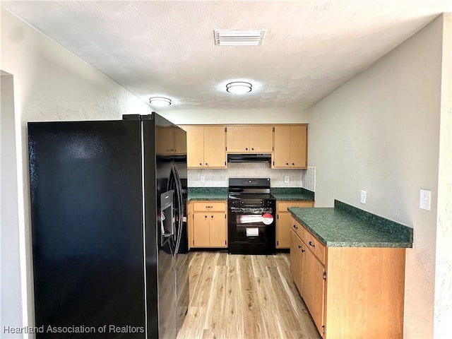 kitchen featuring decorative backsplash, black appliances, and light hardwood / wood-style flooring