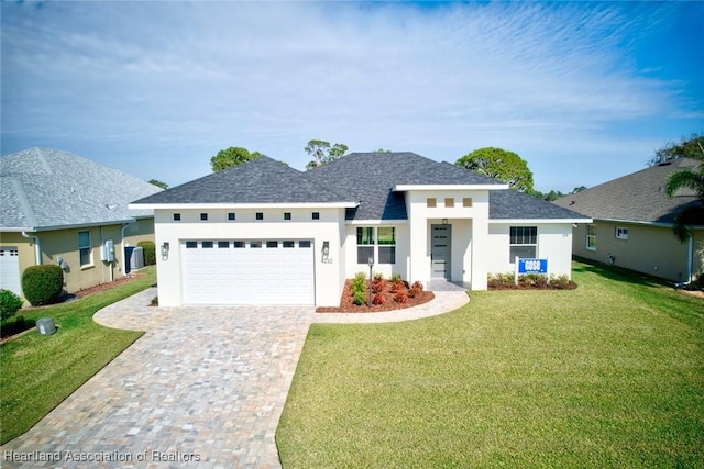 view of front of home with a garage and a front lawn