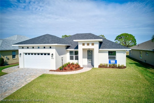 view of front facade with a garage and a front lawn