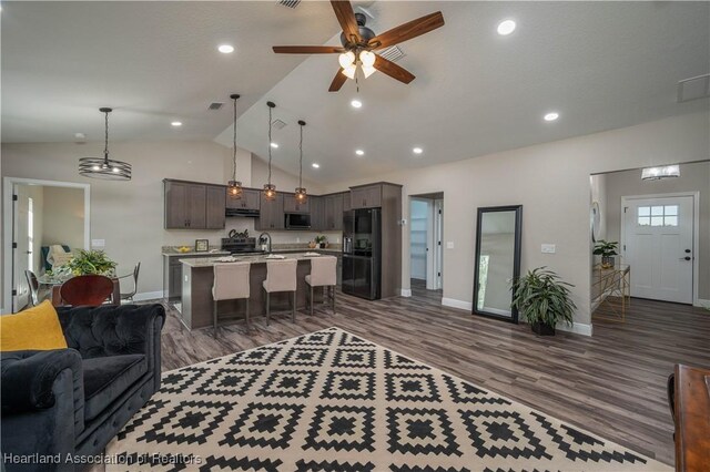 living room with lofted ceiling, ceiling fan, sink, and dark hardwood / wood-style floors