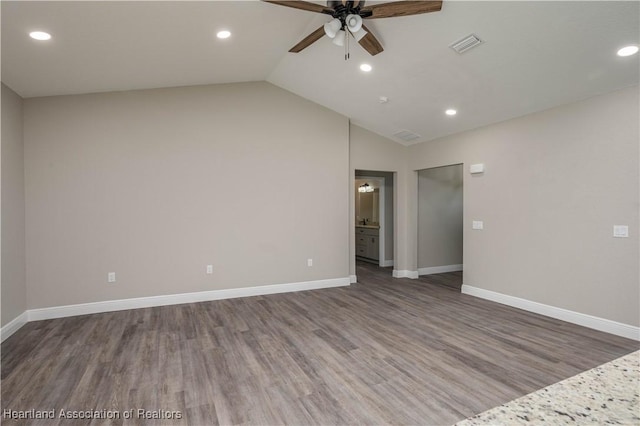 unfurnished room featuring ceiling fan, hardwood / wood-style floors, and vaulted ceiling