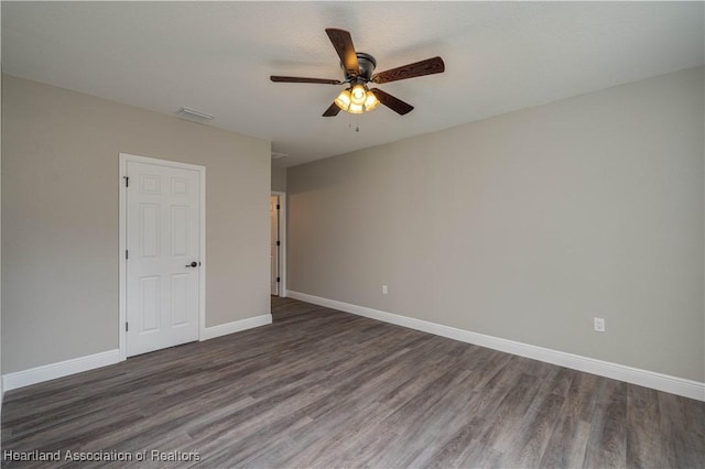 unfurnished room with ceiling fan and dark hardwood / wood-style flooring