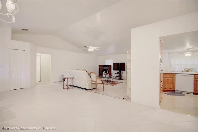 living room with ceiling fan, lofted ceiling, and light tile patterned flooring