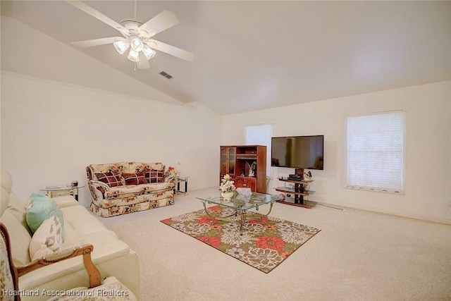 carpeted living room featuring ceiling fan and vaulted ceiling