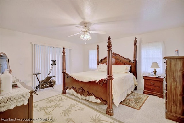 bedroom featuring carpet flooring, multiple windows, and ceiling fan