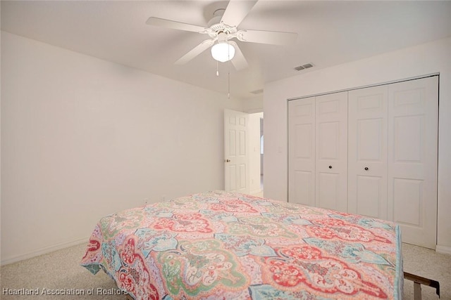 carpeted bedroom with ceiling fan and a closet