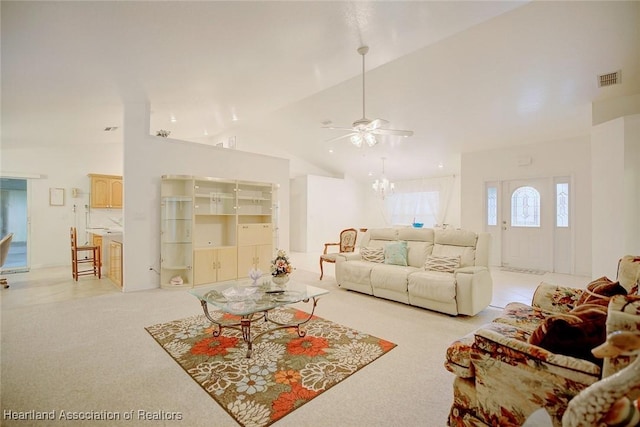 carpeted living room featuring ceiling fan and high vaulted ceiling