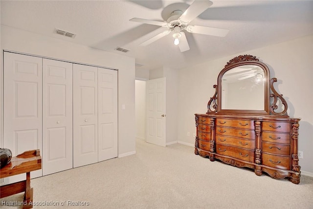 carpeted bedroom with a closet and ceiling fan