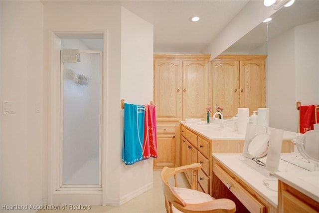 bathroom with vanity and a shower with shower door