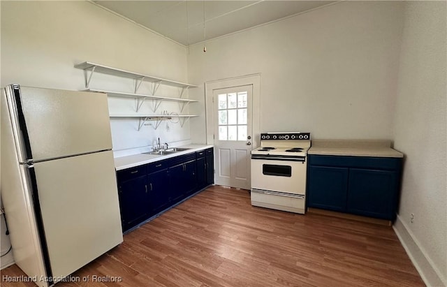 kitchen featuring wood-type flooring, white appliances, blue cabinets, and sink