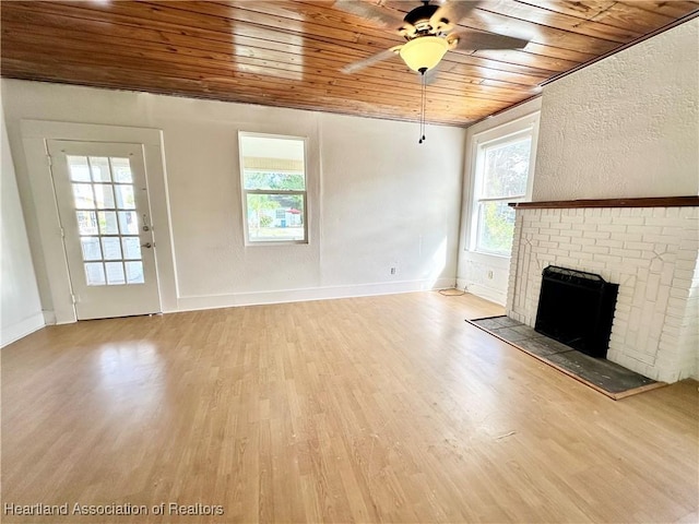 unfurnished living room with a fireplace, light wood-type flooring, ceiling fan, and wooden ceiling