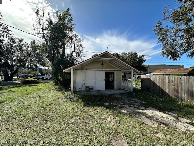 back of property with a lawn and an outbuilding