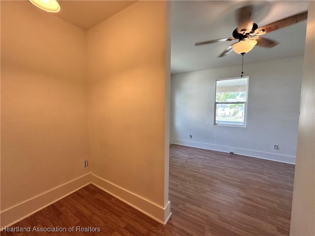 empty room featuring ceiling fan and dark wood-type flooring