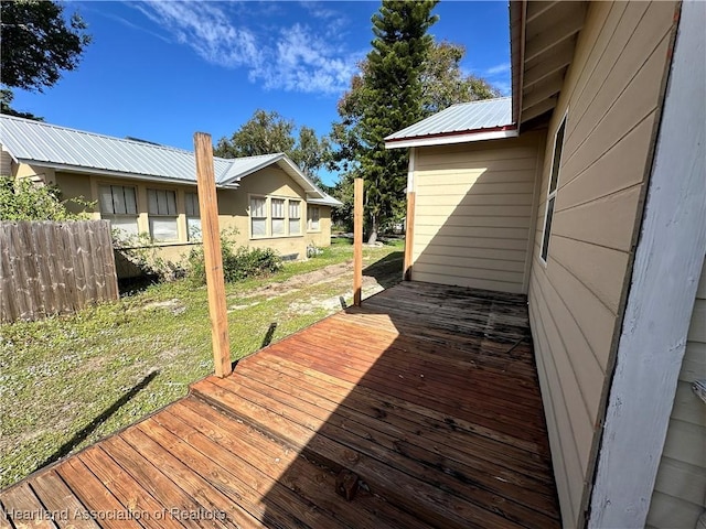 wooden deck with a lawn