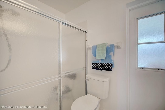 bathroom featuring toilet and walk in shower