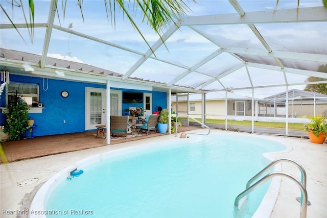 view of pool with a lanai and a patio area