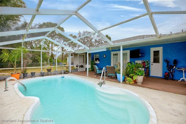 view of pool with a lanai and a patio area