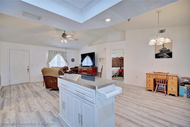 kitchen with ceiling fan with notable chandelier, white cabinets, decorative light fixtures, vaulted ceiling, and light hardwood / wood-style flooring