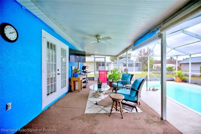 sunroom / solarium with ceiling fan and french doors