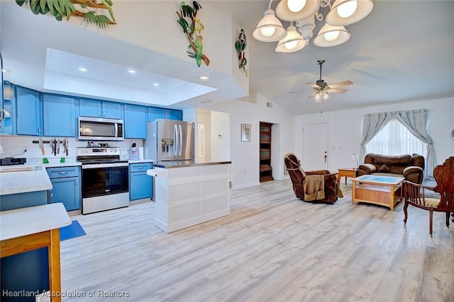 kitchen with ceiling fan, light hardwood / wood-style floors, a raised ceiling, appliances with stainless steel finishes, and blue cabinets