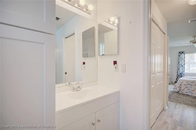 bathroom featuring ceiling fan, vanity, and hardwood / wood-style floors