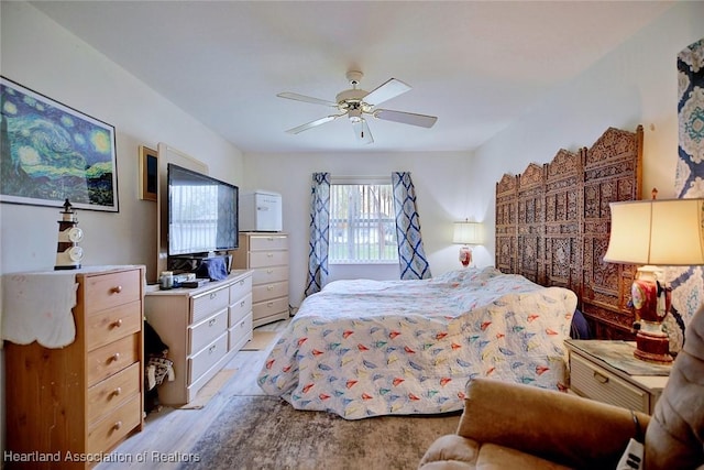 bedroom with ceiling fan and light hardwood / wood-style flooring