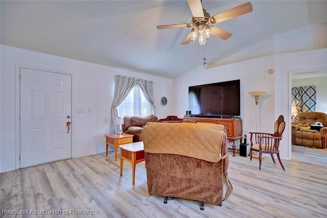 living room featuring vaulted ceiling, ceiling fan, and light hardwood / wood-style floors