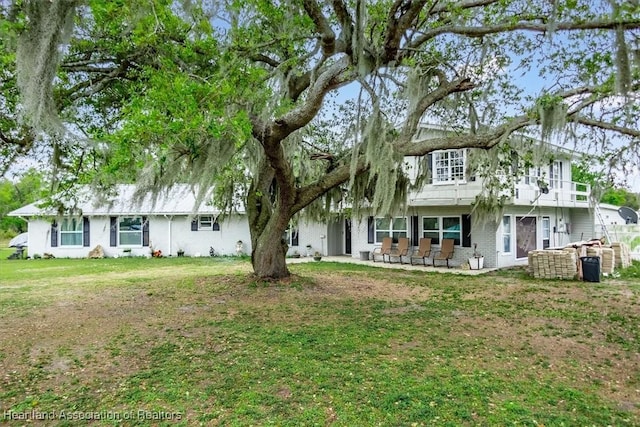 view of front of home with a patio area and a front yard