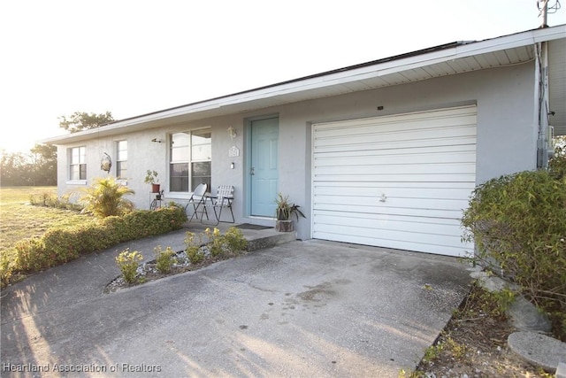 1820 W Batavia Rd, Avon Park, FL 33825 - view of front of property featuring concrete driveway, an attached garage, and stucco siding
