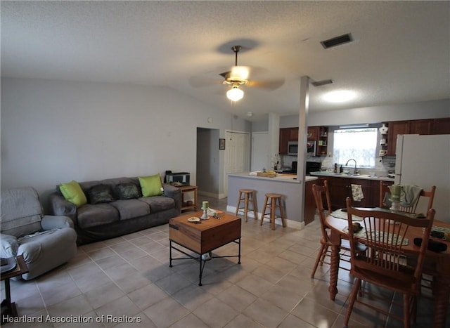 1820 W Batavia Rd, Avon Park, FL 33825 - living room with lofted ceiling, a ceiling fan, light tile patterned flooring, and visible vents
