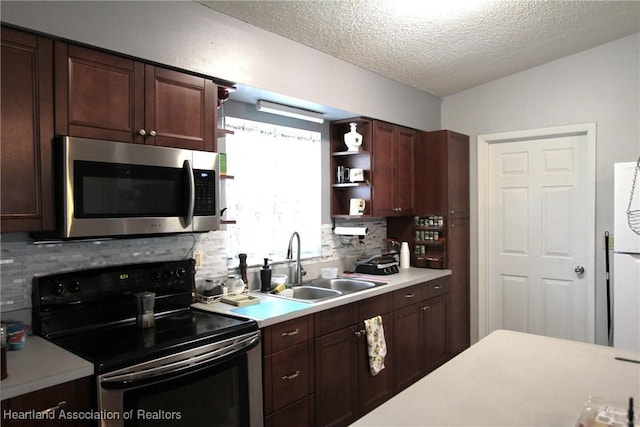 1820 W Batavia Rd, Avon Park, FL 33825 - kitchen featuring light countertops, a sink, stainless steel microwave, and electric range