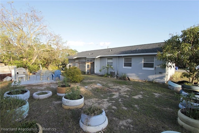 1820 W Batavia Rd, Avon Park, FL 33825 - rear view of property featuring central AC, a shingled roof, a patio, and stucco siding