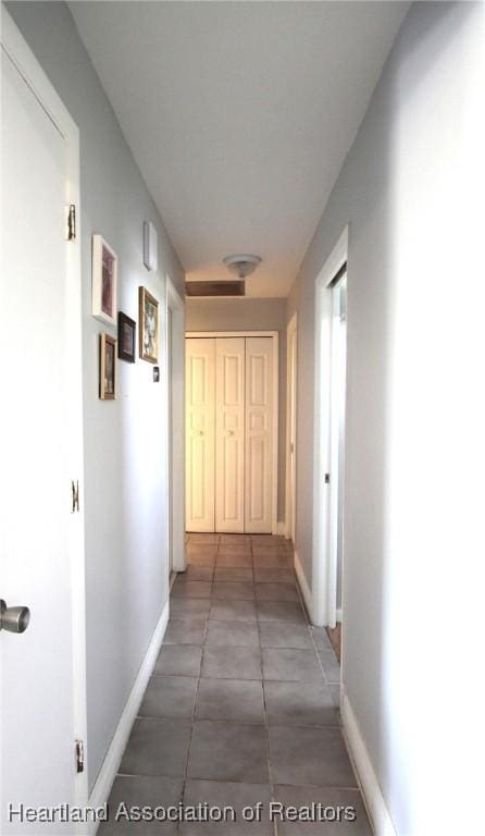 1820 W Batavia Rd, Avon Park, FL 33825 - corridor featuring baseboards and tile patterned flooring